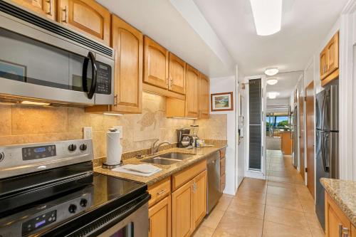 a kitchen with a sink and a microwave at Aston Maui Kaanapali Villas in Lahaina