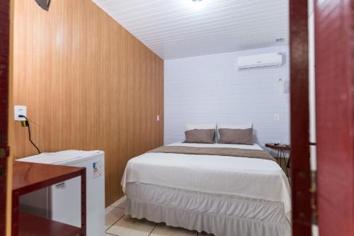 Postel nebo postele na pokoji v ubytování Hotel Coração Verde