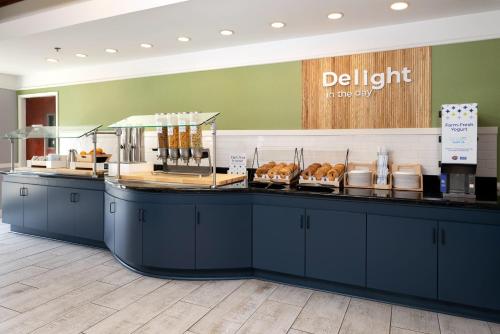 a bakery with a counter with pastries on it at Spark by Hilton Savannah Airport in Savannah