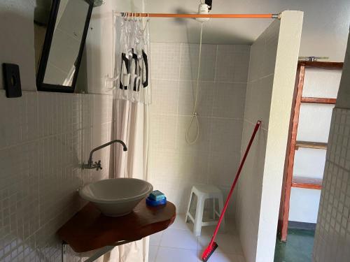 a bathroom with a sink and a shower at Chalé Único in Alto Paraíso de Goiás
