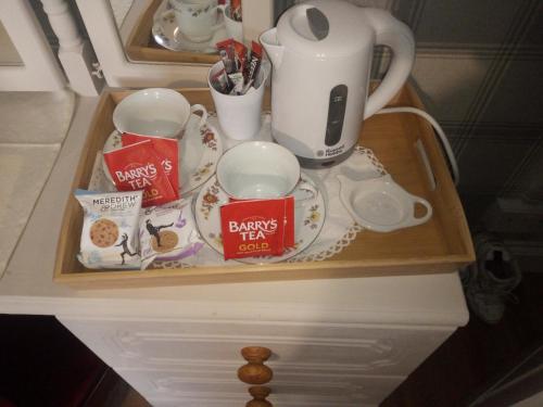 a tray with cups and a coffee maker on a counter at Blackbrink cottage in Roscommon