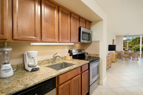 a kitchen with a sink and a counter top at Aston Maui Kaanapali Villas in Lahaina