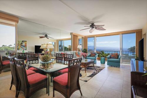 a living room with a table and chairs and a couch at Aston Maui Kaanapali Villas in Lahaina