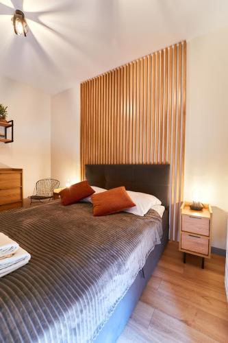 a bedroom with a bed with two pillows on it at LAGUNA Loftowy na Wzgórzu in Polanica-Zdrój