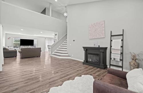 a living room with a fireplace and a staircase at 3BR Secret Gem in Phoenix