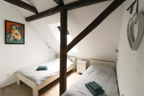 a bedroom with two twin beds in a attic at apartman liker in Ravna Gora