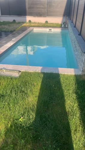 une piscine dans l'herbe à côté d'une maison dans l'établissement Villa Aqua Détente, à Ingersheim