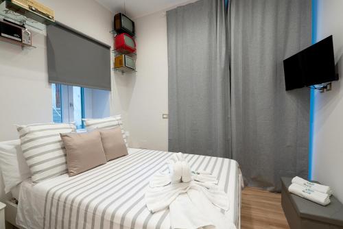 a bedroom with a bed with towels on it at Vittorio Emanuele Suite in Castellammare di Stabia