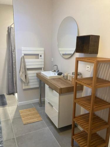 une salle de bain avec un lavabo et un miroir dans l'établissement Maison plain-pied - Guidel, à Guidel