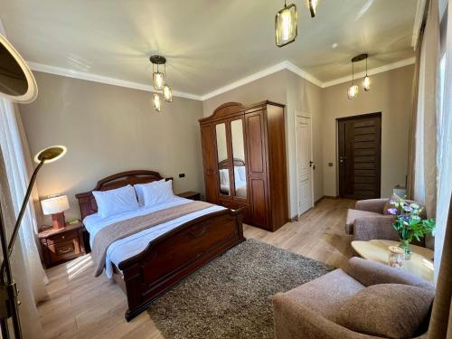 a bedroom with a bed and a couch and a chair at Rancho by HV in Sevan
