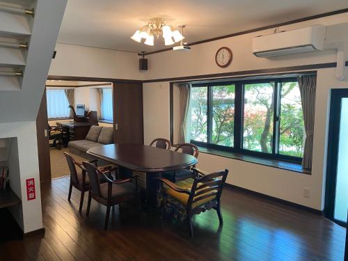a dining room and living room with a table and chairs at 高野山 こころの寺子屋リトリートハウス -Koyasan Retreat House IKKOSHO in Koyasan