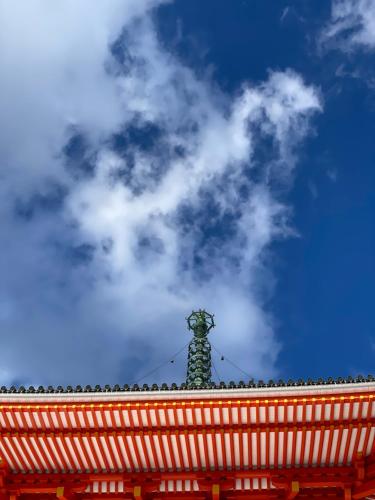 a cross on top of a building with a cloudy sky at 高野山 こころの寺子屋リトリートハウス -Koyasan Retreat House IKKOSHO in Koyasan
