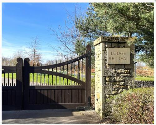 a gate with a lodge retrieval sign in front of a fence at Lodge Retreat 8 - Haggerston Castle in Berwick-Upon-Tweed