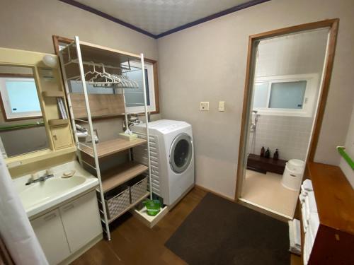 a bathroom with a washer and a washing machine in it at 高野山 こころの寺子屋リトリートハウス -Koyasan Retreat House IKKOSHO in Koyasan
