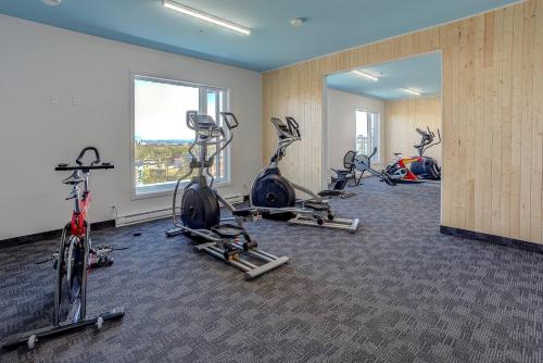 a gym with several exercise bikes in a room at Sommet de la basse ville in Quebec City