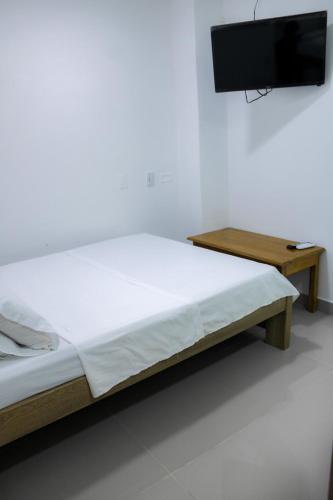 Ένα ή περισσότερα κρεβάτια σε δωμάτιο στο Hotel San Andres Arboletes