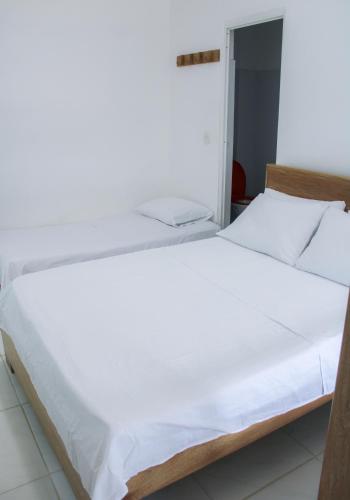 Ένα ή περισσότερα κρεβάτια σε δωμάτιο στο Hotel San Andres Arboletes