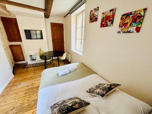 a bedroom with a bed and a table at Louis Premier et Second Metz Centre Un Séjour à Part in Metz