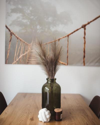 a vase with feathers in it sitting on a table at Villa Gall in Český Krumlov