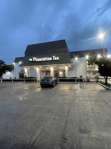 a car parked in front of a parking lot at Plantation Inn in Houma