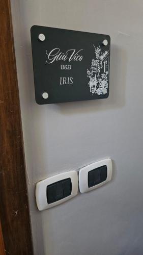 a sign on a refrigerator with two controllers on it at Gliù Vico in Formia