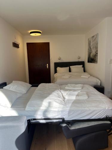two twin beds in a room with at La Perle Montana in Crans-Montana