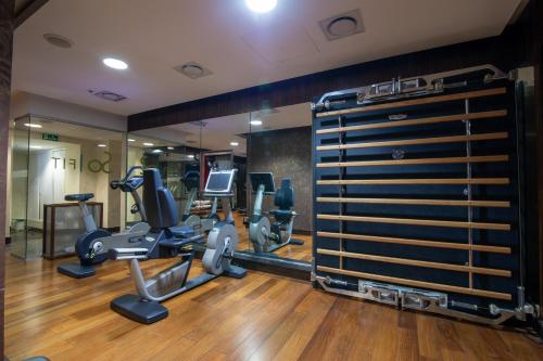a gym with treadmills and cardio equipment in a room at Sofitel Montevideo Casino Carrasco & Spa in Montevideo