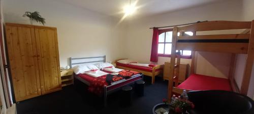 a room with two beds and a bunk bed at Táltos Vendégház in Szilvásvárad