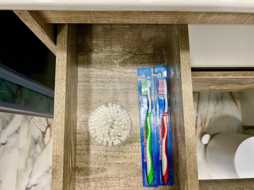 two toothbrushes are in a wooden drawer at Rancho on Sevan beach by HV in Sevan