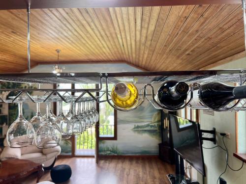 a bunch of wine glasses hanging from a wine rack at Rancho on Sevan beach by HV in Sevan