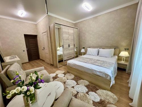 a bedroom with a large bed and a couch at Rancho on Sevan beach by HV in Sevan