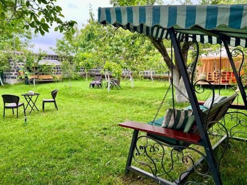 a swing in a yard with chairs and a table at Rancho on Sevan beach by HV in Sevan