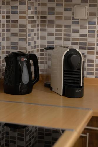 a coffee maker and toaster sitting on a counter at La Femme Apartment in Chrysoupolis
