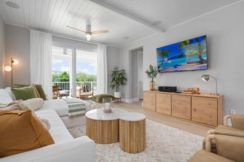 a living room with a couch and a table at CASA NICA! Luxury Private Pool Home with dock on a saltwater canal! in Bradenton