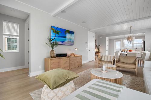a living room with a couch and a table at CASA NICA! Luxury Private Pool Home with dock on a saltwater canal! in Bradenton
