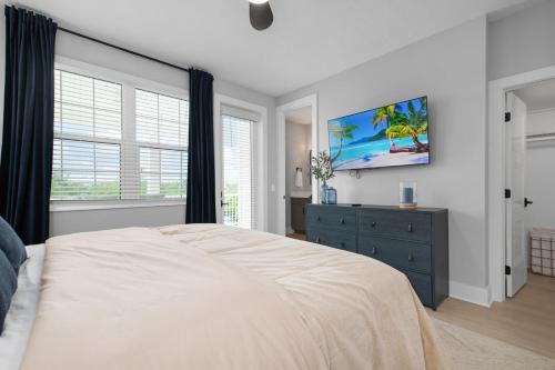 a bedroom with a large bed and a blue dresser at CASA NICA! Luxury Private Pool Home with dock on a saltwater canal! in Bradenton