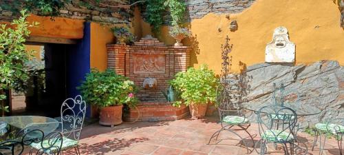 a patio with tables and chairs in front of a building at El Mirador de Las Jaras in Patones