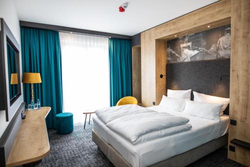 Postel nebo postele na pokoji v ubytování Das Steinmüller Hotel
