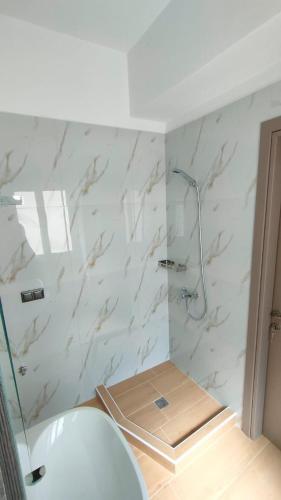 a bathroom with a shower and a sink at Evmaria 2 in Ermoupoli