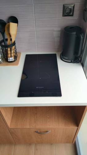 a kitchen counter with a black microwave on it at Evmaria 2 in Ermoupoli