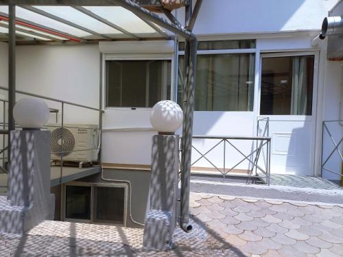 a building with two sculptures on the side of it at Sam's View City Heart Tripoli - Beautiful Apartment With Backyard in Tripolis