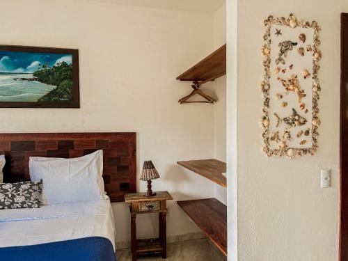 a bedroom with a bed and a stairway to a room at Conchas do Mar Residence in Itacaré