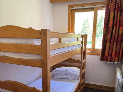 deux lits superposés dans une chambre avec fenêtre dans l'établissement Résidence Le Centaure - 2 Pièces pour 6 Personnes 641, à Aime La Plagne