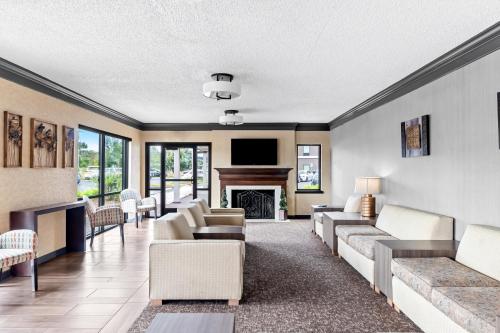 a living room with couches and a fireplace at Red Lion Hotel Portland Airport in Portland