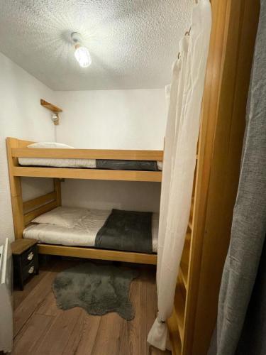Cette chambre comprend 2 lits superposés et du parquet. dans l'établissement Résidence Le Pastourlet - RESIDENCE LE PASTOURLET-Classé 3 MAE-4531, à Vars
