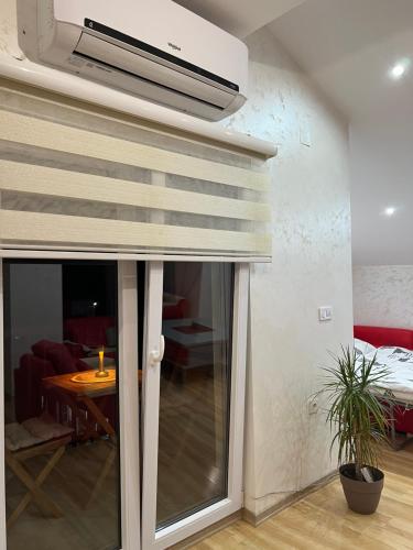 a room with a sliding glass door and a living room at Luxury Apartment in Struga