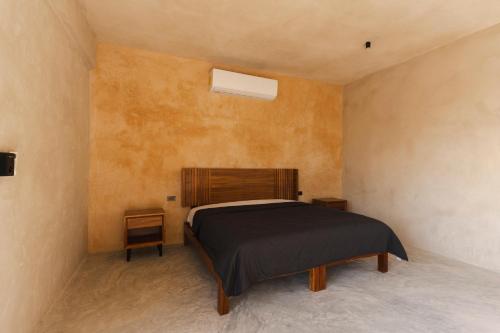 a bedroom with a bed and two night stands at Casa Re Valladolid in Valladolid