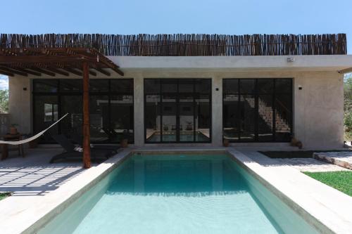 a swimming pool in front of a house at Casa Re Valladolid in Valladolid