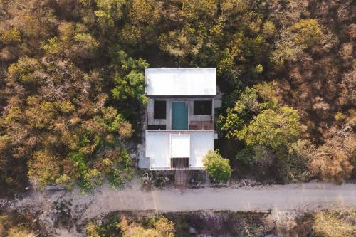 an aerial view of a house in the middle of a forest at Casa Re Valladolid in Valladolid