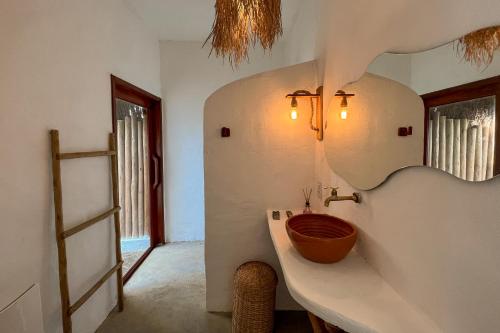 a bathroom with a sink and a mirror at Araxá Milagres in São Miguel dos Milagres
